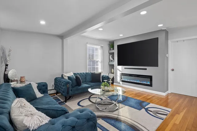 a living room with furniture and a flat screen tv