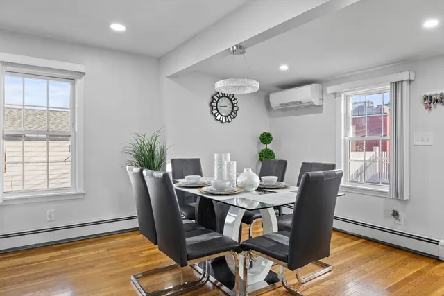 a view of a dining room with furniture window and wooden floor
