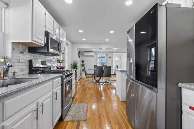 a kitchen with stainless steel appliances granite countertop refrigerator a sink and a stove top oven