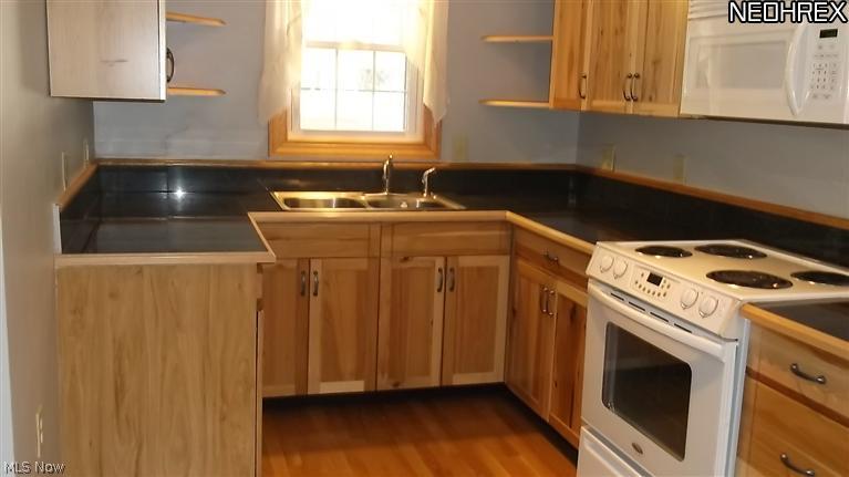 4335 7th Street Northwest Canton, OH 44708 - Photo 4 of 21 Kitchen features hardwood floors, new cabinetry, granite counter tops,stainless sink and appliances