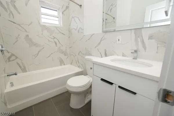 a bathroom with a sink a toilet and bathtub