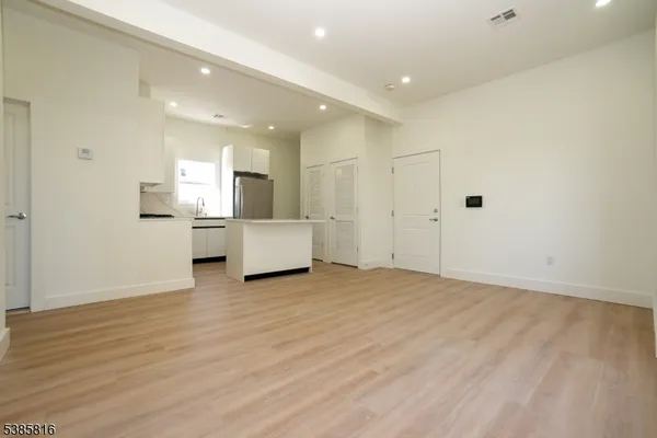 a view of a kitchen with a sink and a refrigerator