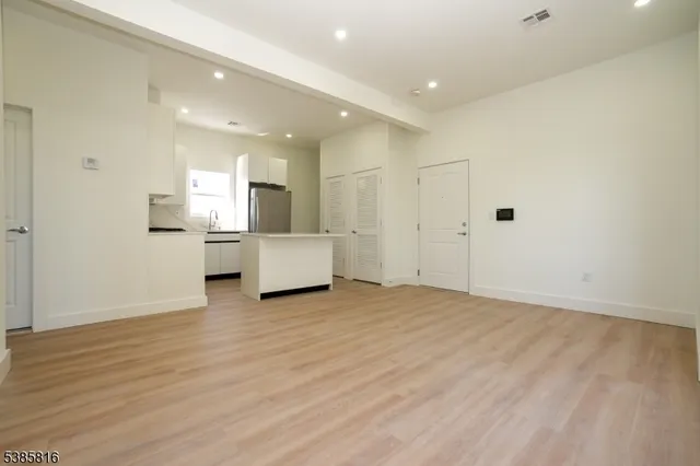a view of a kitchen with a sink and a refrigerator