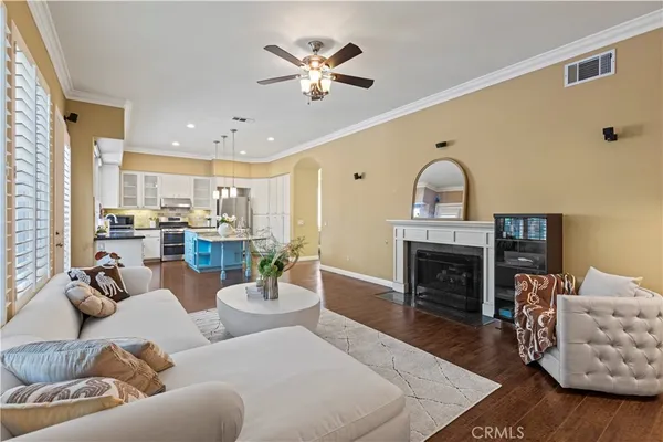 a living room with furniture a fireplace and a chandelier