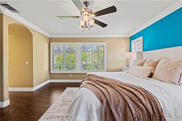 a bedroom with a large bed and a window