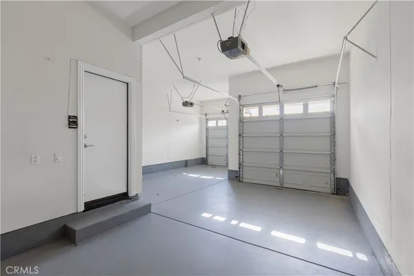 a view of a room with wooden floor and white walls