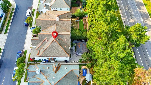 an aerial view of residential houses with outdoor space and swimming pool