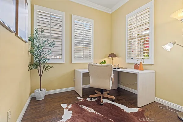 a view of a workspace with furniture and a window