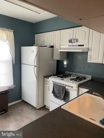 an empty room with closet and windows