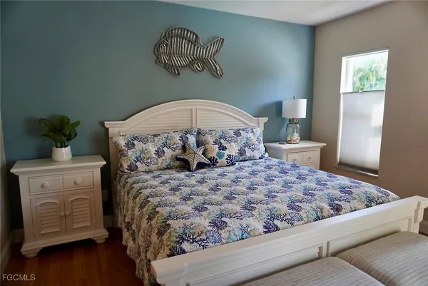 a bed sitting in a bedroom next to a window