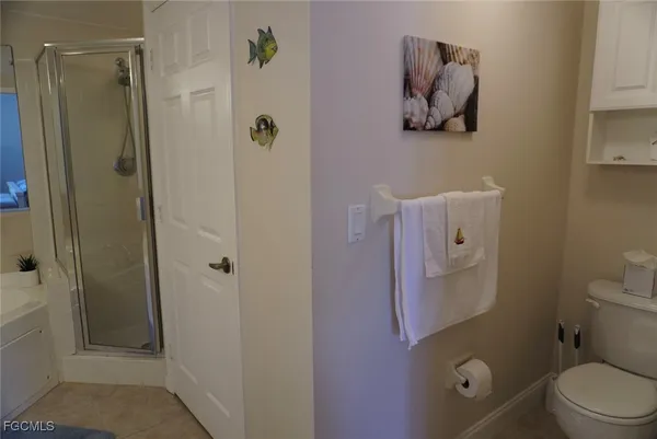 a bathroom with a toilet and a shower