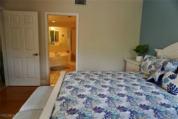 a bedroom with a bed and hallway