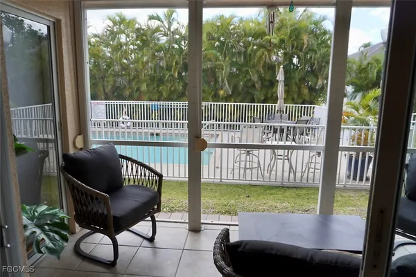 a view of a chair and tables in the balcony