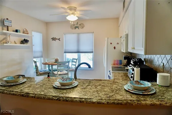 a kitchen with a table and chairs