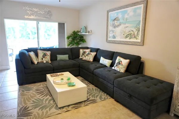 a living room with furniture and a large window