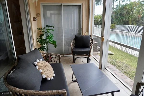 a living room with furniture flowerpot and wooden floor