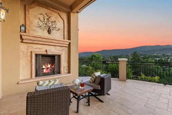 a balcony with furniture and a fireplace