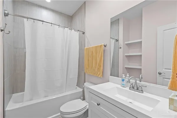 a bathroom with a toilet and a bathtub