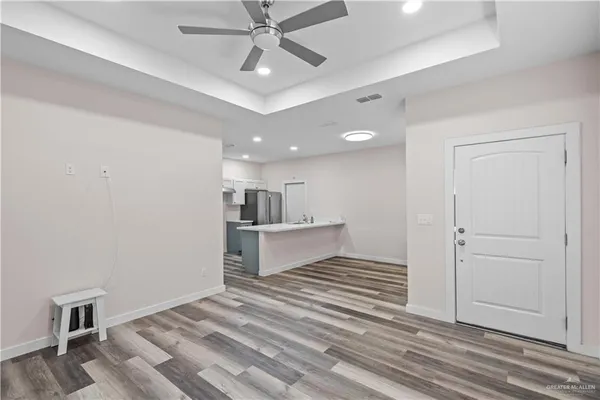 a kitchen with a sink cabinets and wooden floor