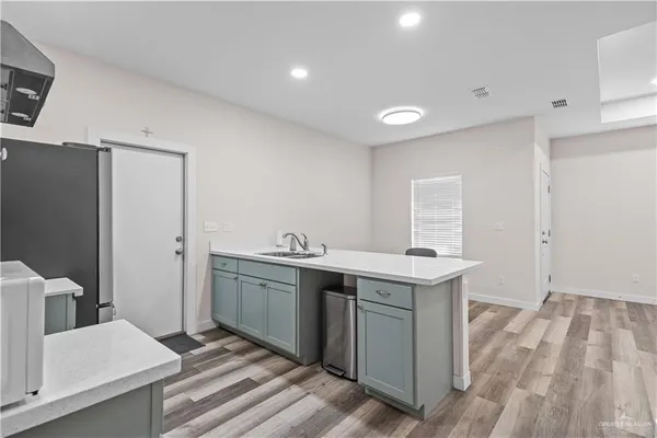 a kitchen with a sink a stove and refrigerator