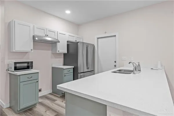 a view of kitchen with wooden floor