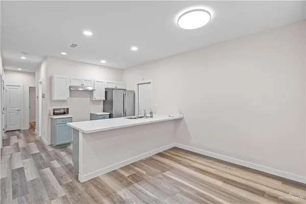 an empty room with a window and a ceiling fan