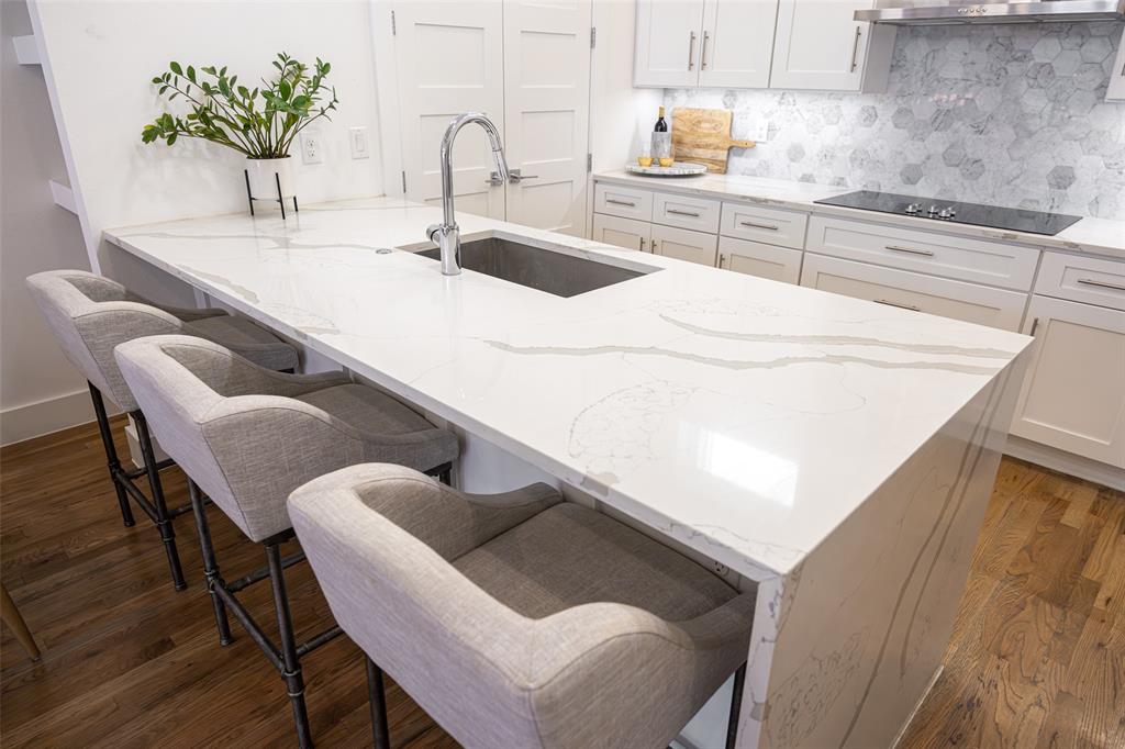 1727 Caddo Street, Unit 103 Dallas, TX 75204 - Photo 11 of 27 a kitchen with a table chairs and a sink
