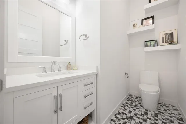 a bathroom with a sink toilet and a mirror
