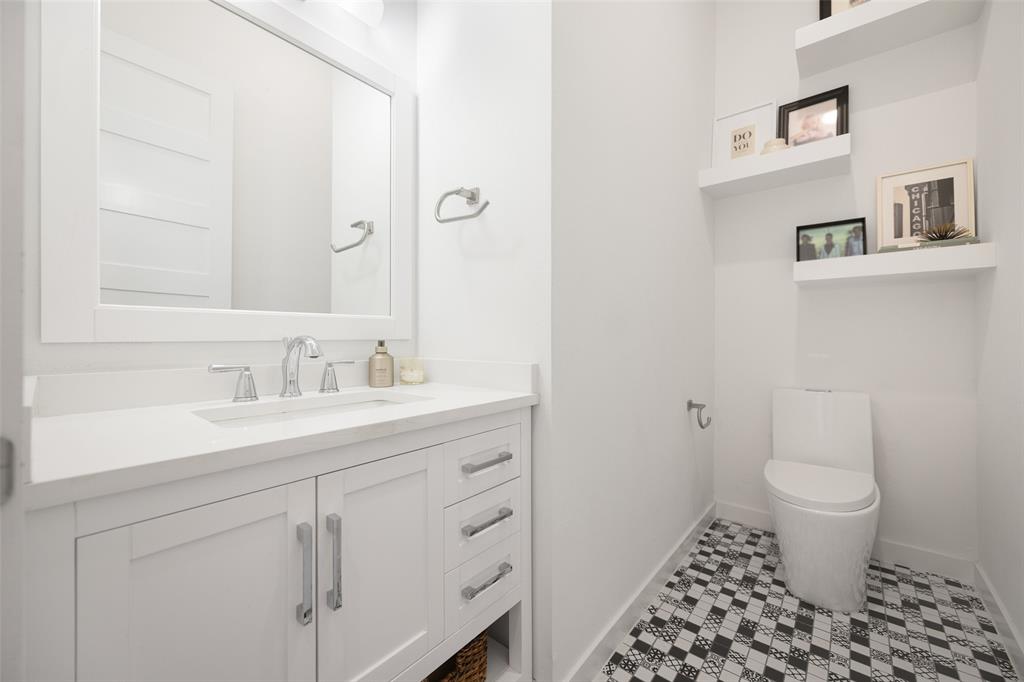 1727 Caddo Street, Unit 103 Dallas, TX 75204 - Photo 16 of 27 a bathroom with a sink toilet and a mirror