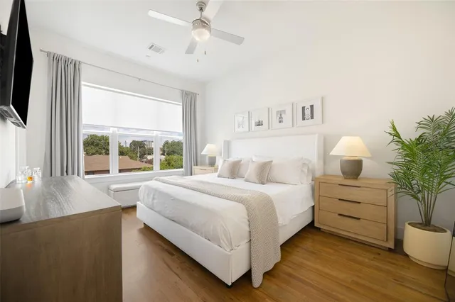 a bedroom with a large bed and a window