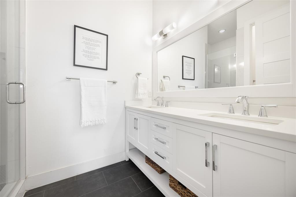 1727 Caddo Street, Unit 103 Dallas, TX 75204 - Photo 20 of 27 a bathroom with a double vanity sink a mirror and a shower