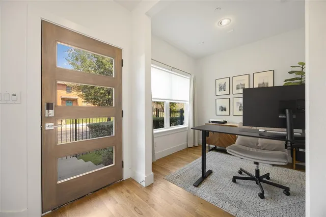 a view of a livingroom with workspace and windows