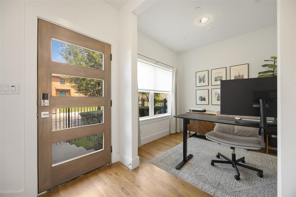 1727 Caddo Street, Unit 103 Dallas, TX 75204 - Photo 3 of 27 a view of a livingroom with workspace and windows
