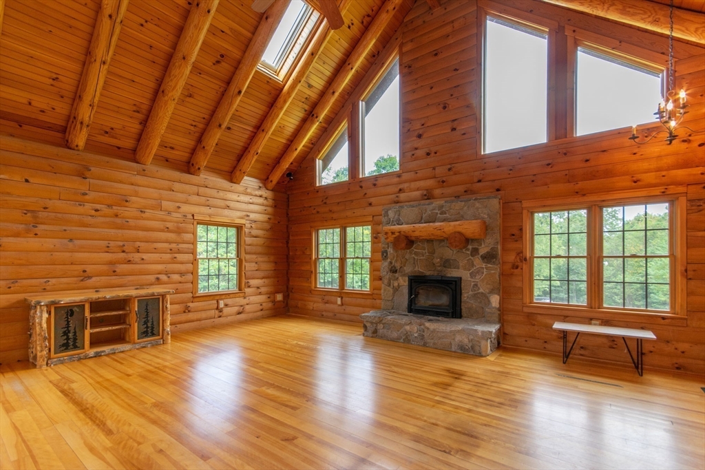 56 Waid Road Monson, MA 01057 - Photo 13 of 41 a view of a livingroom with furniture a fireplace and wooden floor