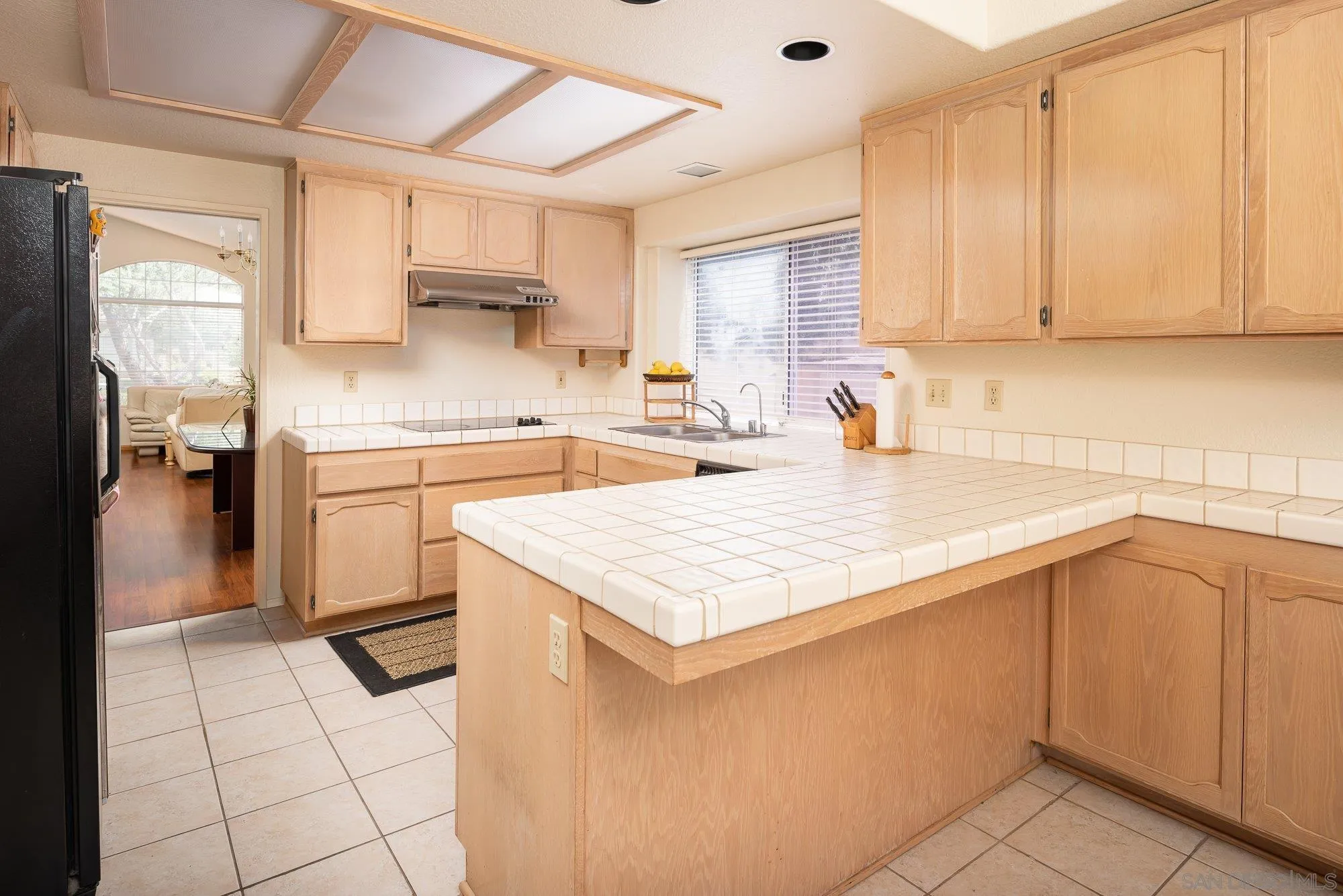 13926 Carriage Road Poway, CA 92064 - Photo 13 of 54 a kitchen with a sink cabinets and window