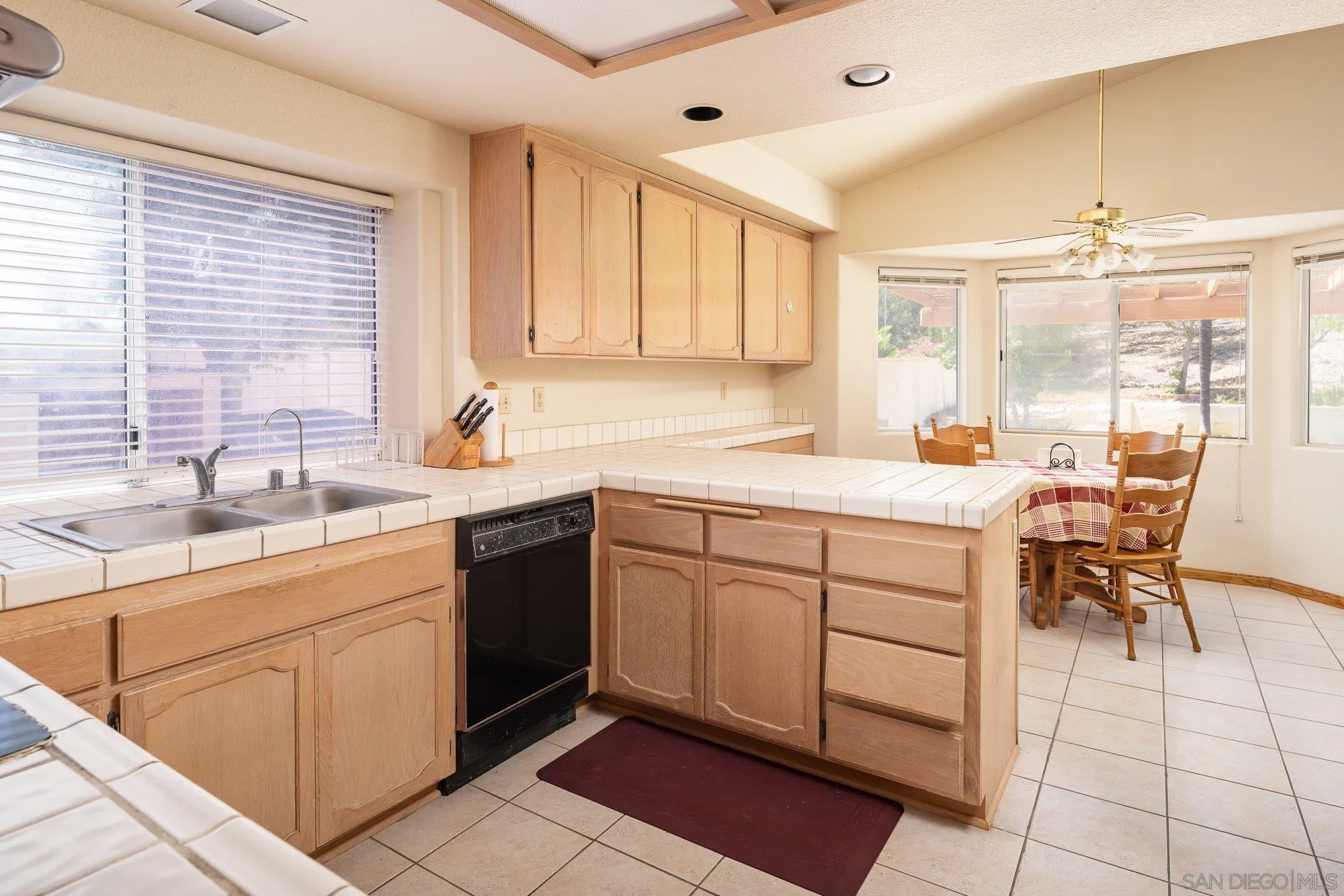 13926 Carriage Road Poway, CA 92064 - Photo 14 of 54 a kitchen with sink cabinets and dining table