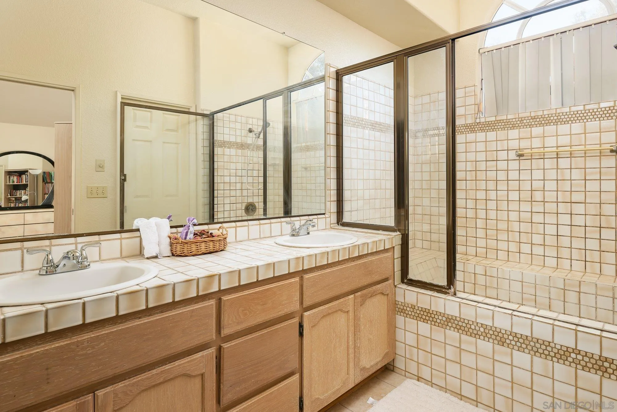 13926 Carriage Road Poway, CA 92064 - Photo 20 of 54 a bathroom with a granite countertop sink and a shower