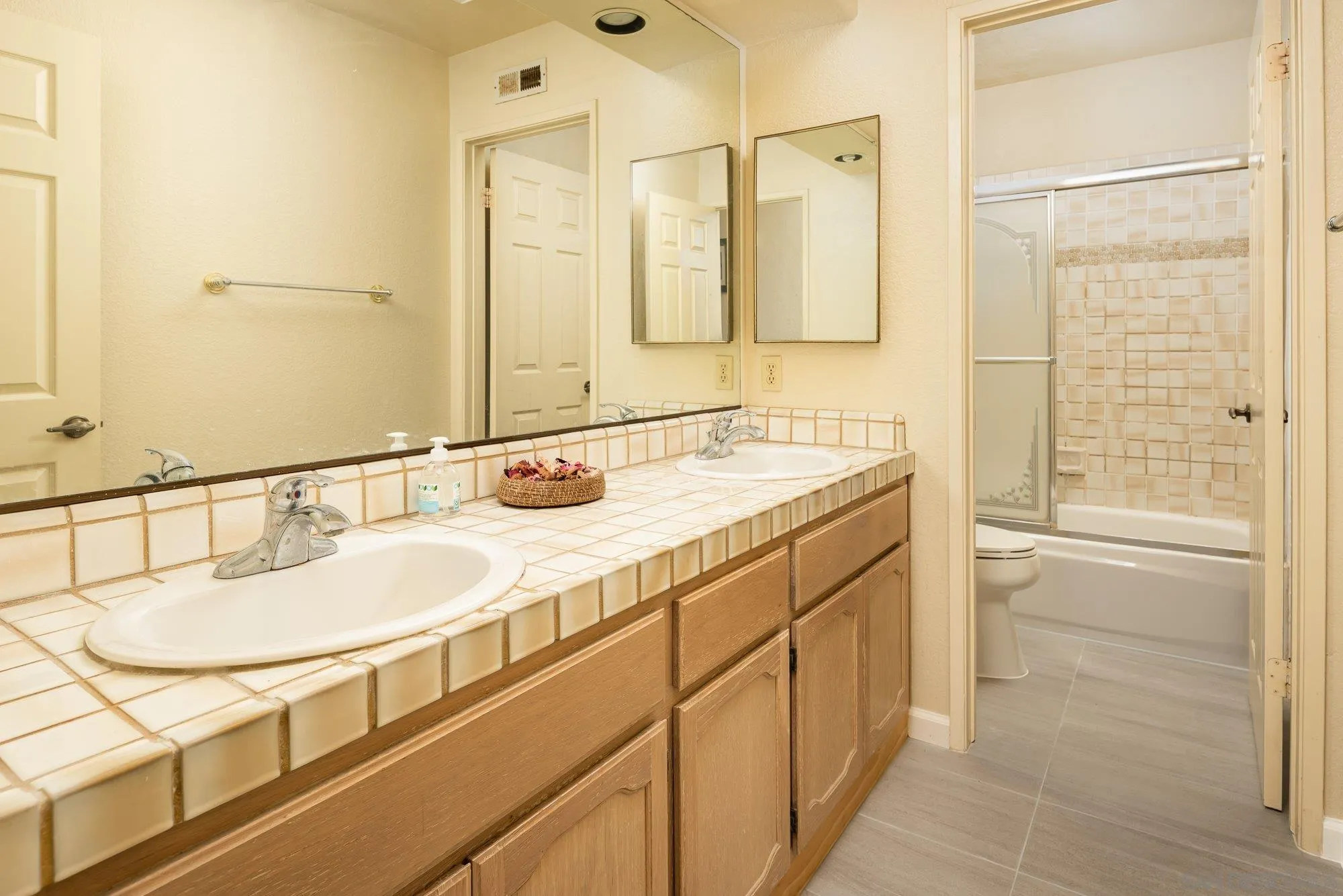 13926 Carriage Road Poway, CA 92064 - Photo 23 of 54 a bathroom with a sink double vanity and a mirror