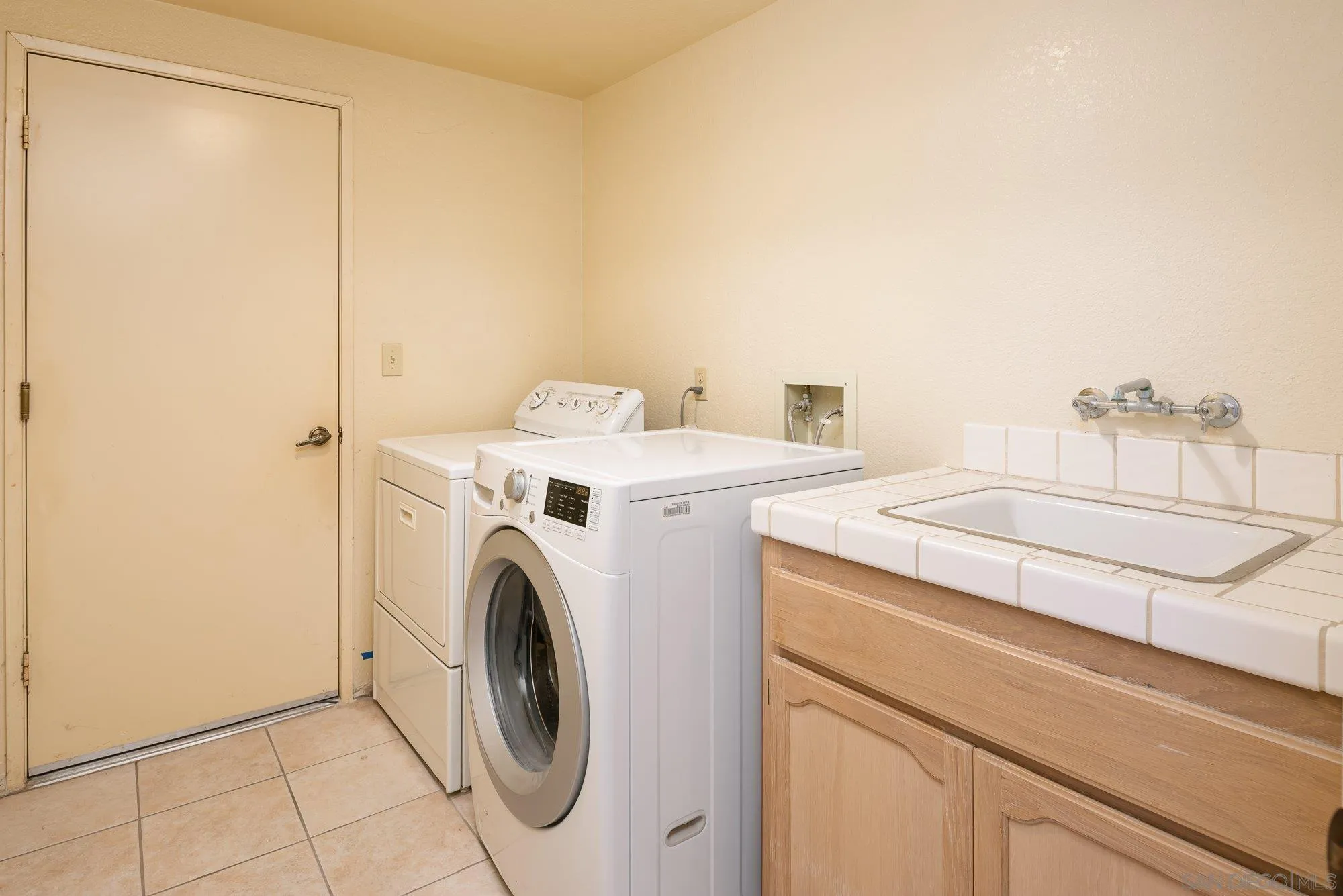 13926 Carriage Road Poway, CA 92064 - Photo 25 of 54 a utility room with dryer and washer