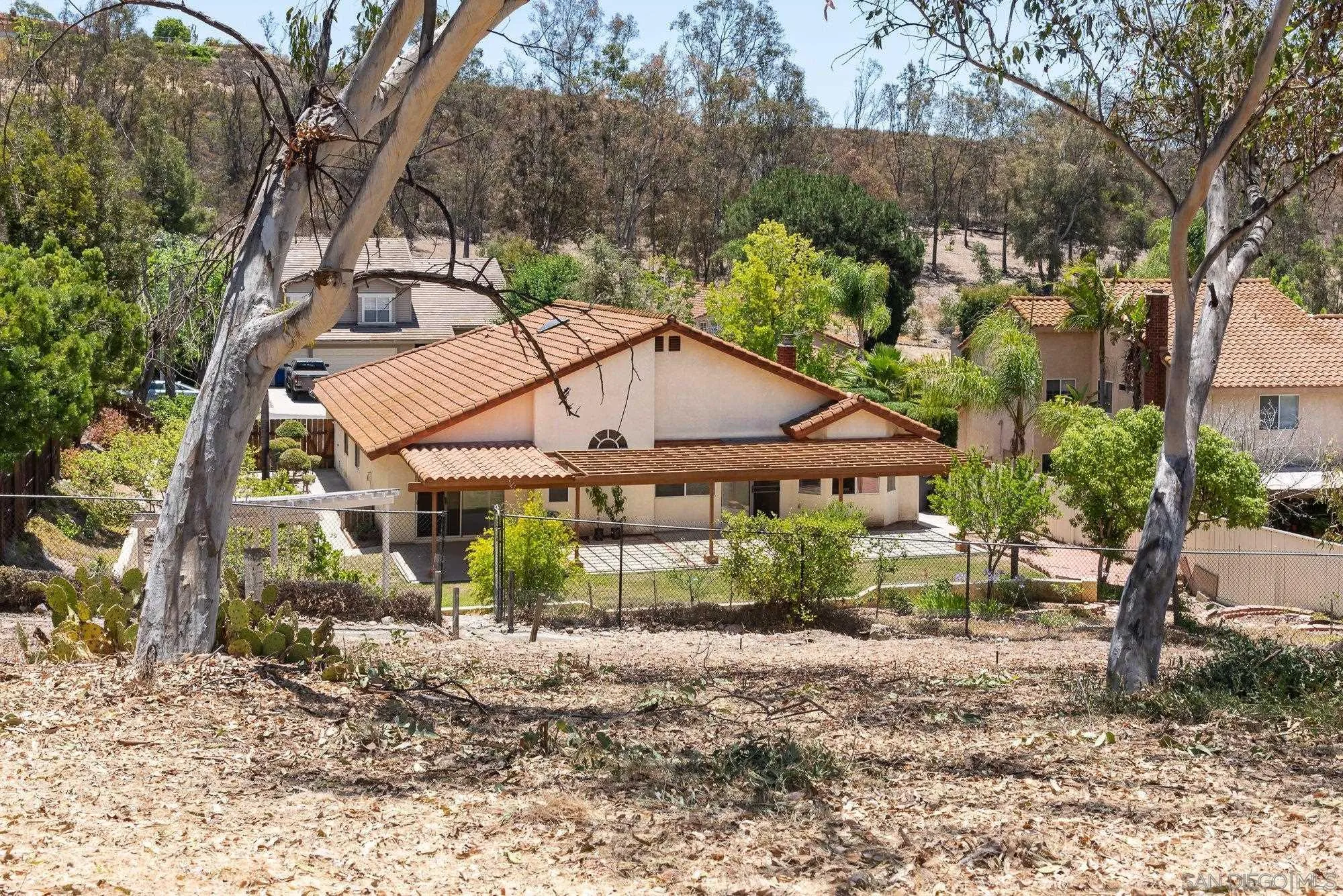 13926 Carriage Road Poway, CA 92064 - Photo 45 of 54 a view of a house with a yard and large trees