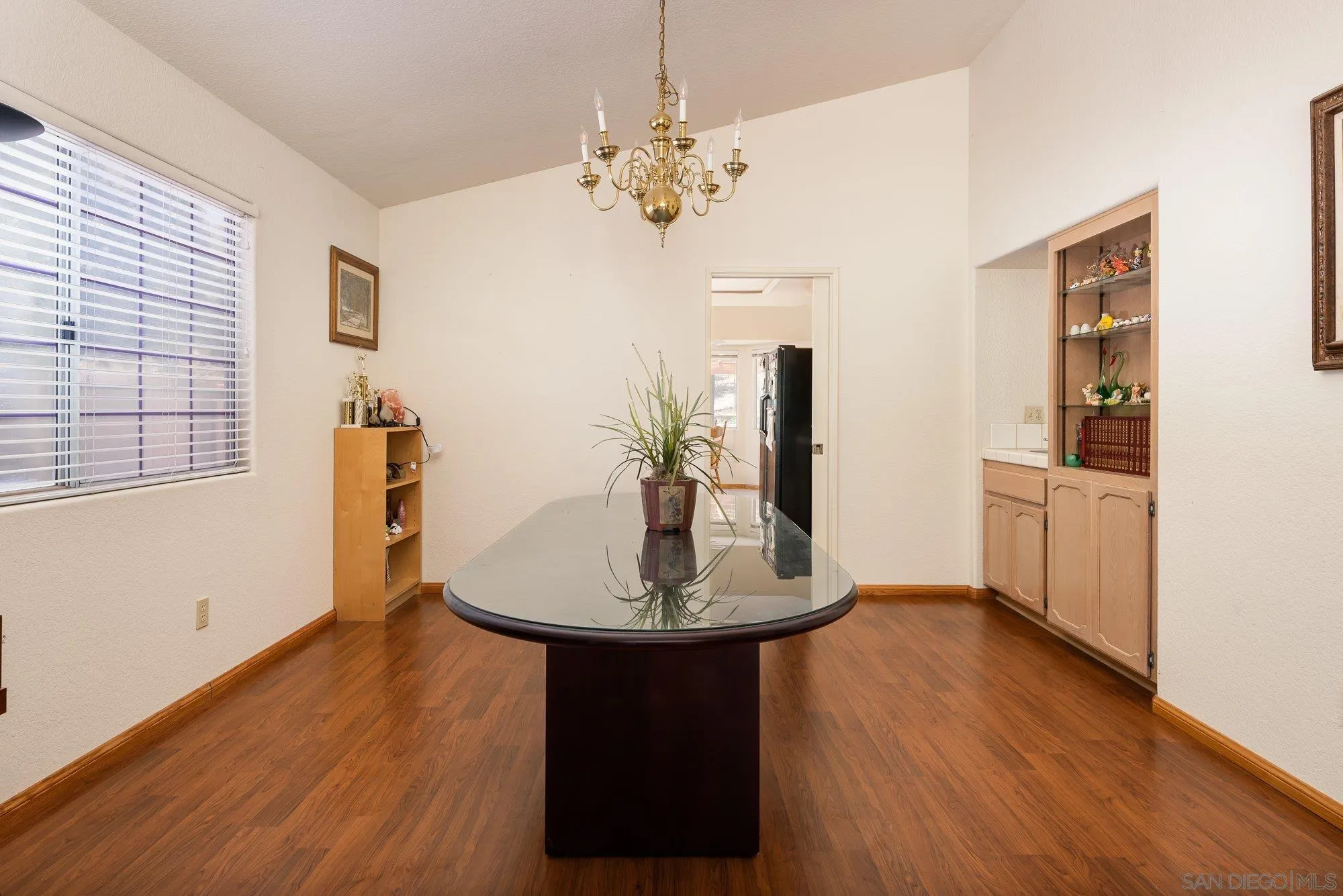 13926 Carriage Road Poway, CA 92064 - Photo 9 of 54 a dining room with chandelier and wooden floor
