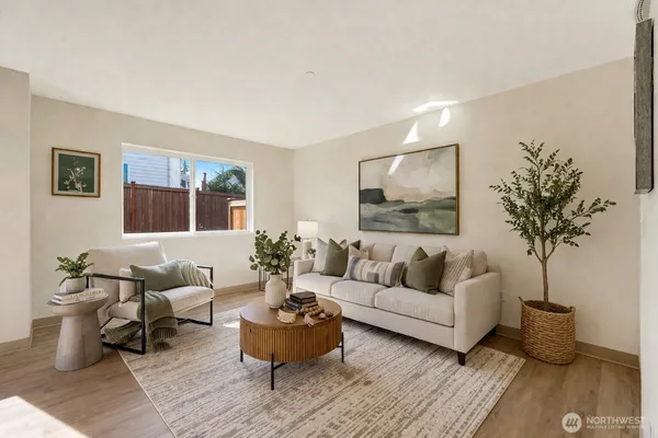 a living room with furniture and a potted plant