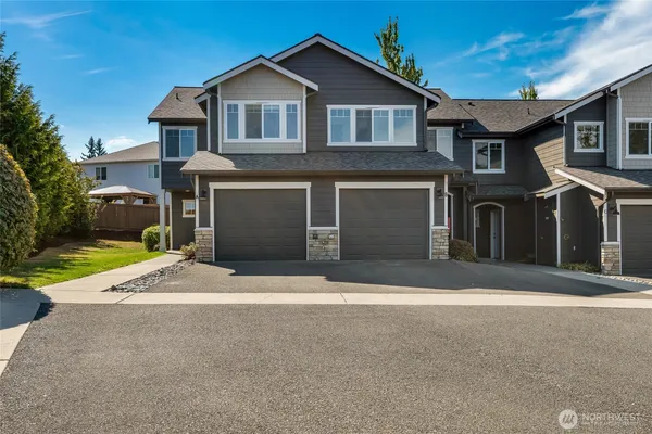 a front view of a house with a yard and garage