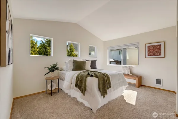 a bed room with a bed and a chair