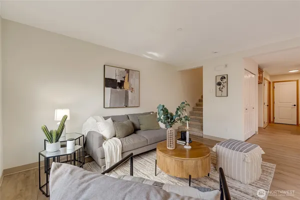 a living room with furniture and a potted plant