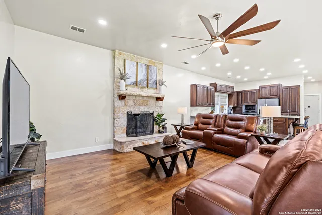 a living room with furniture a fireplace and a flat screen tv