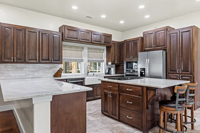a kitchen with stainless steel appliances granite countertop wooden cabinets a sink and dishwasher