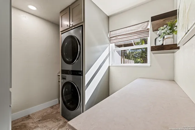 a utility room with window dryer and washer