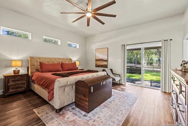 a bed sitting in a bedroom next to a window