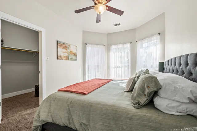 a bedroom with a bed and window